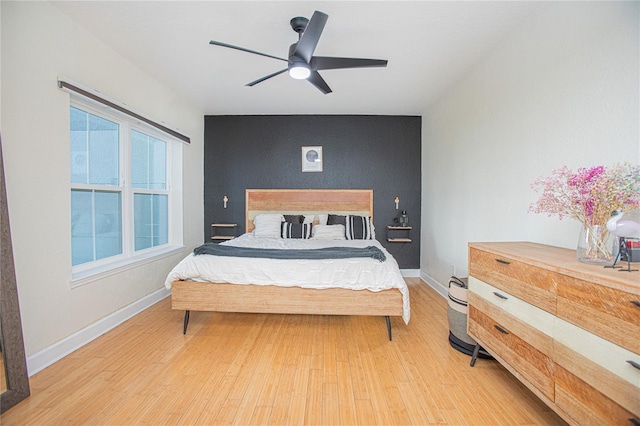 204 E S St Unit 2061, Orlando, FL 32801 - bedroom featuring baseboards, an accent wall, light wood-type flooring, and ceiling fan