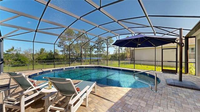 view of swimming pool featuring a patio, glass enclosure, and fence