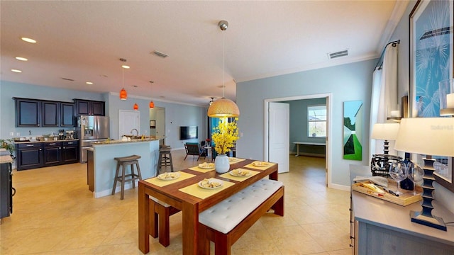 dining space with ornamental molding, recessed lighting, and light tile patterned floors