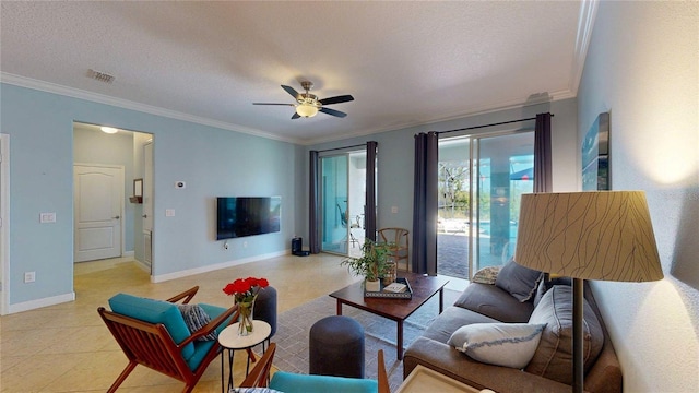 living area with crown molding, a ceiling fan, a textured ceiling, baseboards, and light tile patterned floors