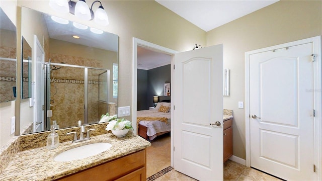 ensuite bathroom with a stall shower, vanity, and tile patterned floors