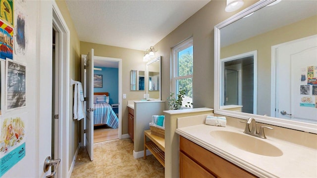 full bath with ensuite bath, vanity, tile patterned floors, and a shower with shower door