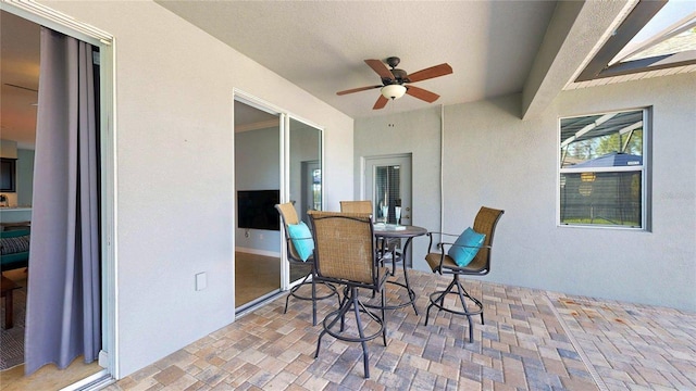view of patio / terrace with ceiling fan and outdoor dining area