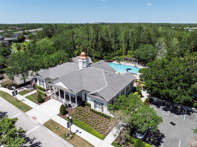 aerial view of property and surrounding area with a forest