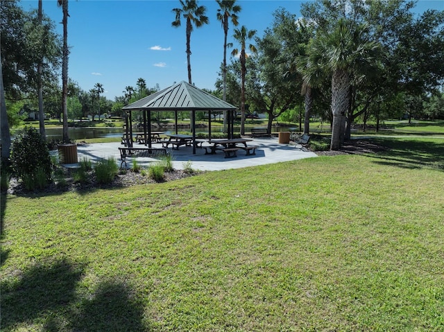 surrounding community with a gazebo, a yard, and a water view