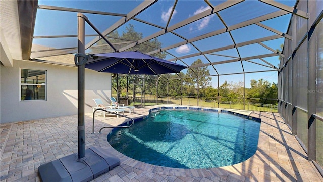 outdoor pool featuring a patio area and glass enclosure