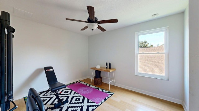 bedroom featuring light wood finished floors, baseboards, and a ceiling fan