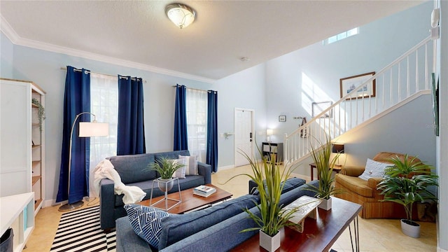 living area featuring stairway, crown molding, light tile patterned flooring, and baseboards