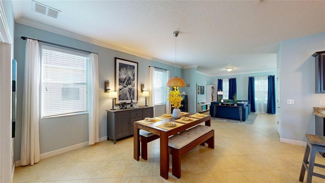 dining space featuring ornamental molding, baseboards, and light tile patterned floors