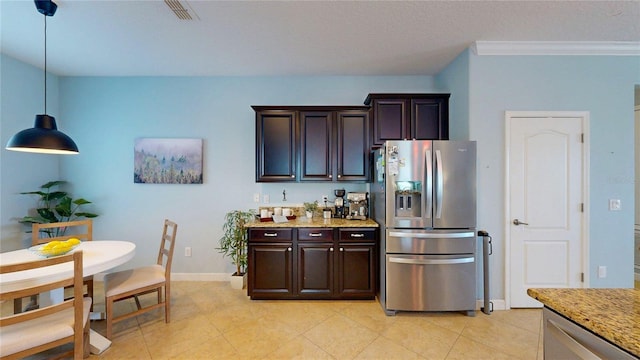 kitchen featuring appliances with stainless steel finishes, light stone counters, dark brown cabinets, light tile patterned flooring, and baseboards