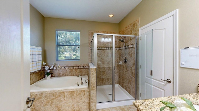bathroom featuring a stall shower and a garden tub
