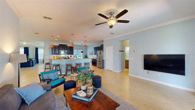 living room with light tile patterned floors, ceiling fan, crown molding, baseboards, and recessed lighting