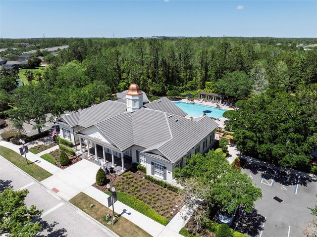 aerial view of property and surrounding area with a forest