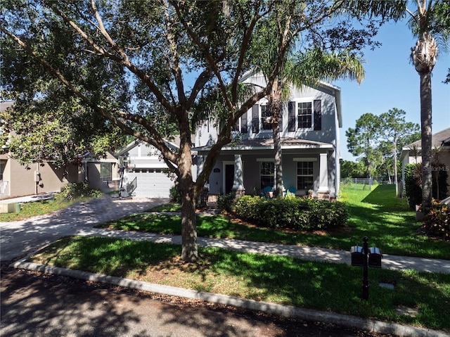 view of front facade with asphalt driveway and a front lawn