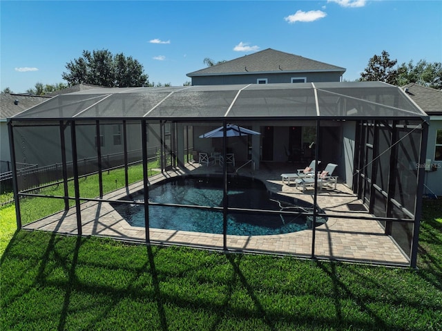 swimming pool with a lanai and a patio area