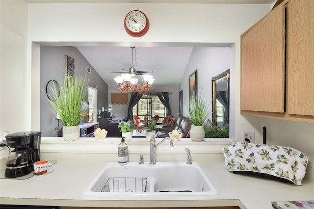 kitchen featuring a ceiling fan, visible vents, a sink, light countertops, and lofted ceiling