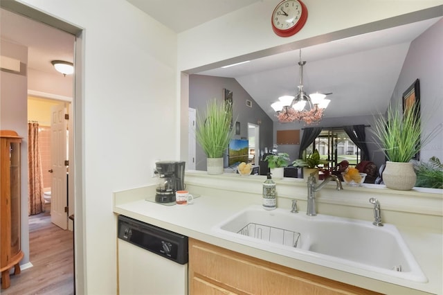 kitchen with pendant lighting, light countertops, a sink, dishwasher, and a notable chandelier