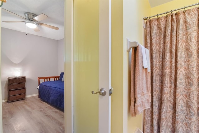 bedroom with baseboards, ceiling fan, and wood finished floors