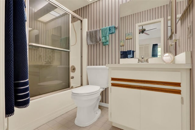 full bathroom featuring a ceiling fan, tile patterned floors, wallpapered walls, vanity, and toilet