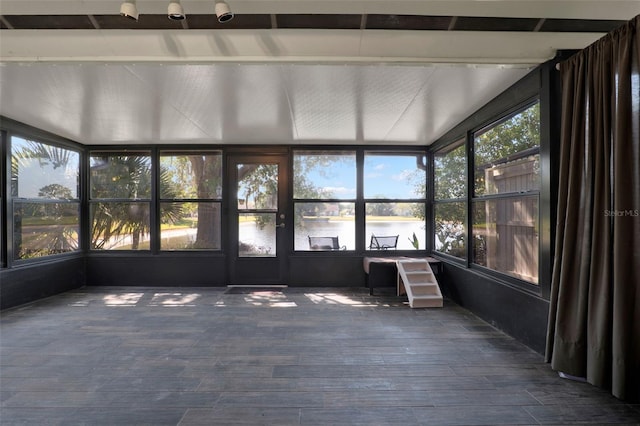 unfurnished sunroom with a water view