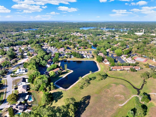 drone / aerial view featuring a residential view, golf course view, and a water view