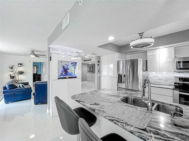 1150 Carmel Cir Unit 301, Casselberry, FL 32707 - kitchen with white cabinets, visible vents, modern cabinets, stainless steel appliances, and a sink