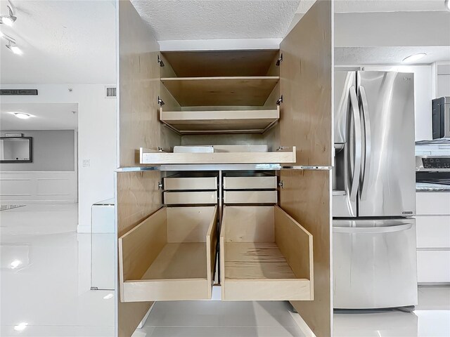 1150 Carmel Cir Unit 301, Casselberry, FL 32707 - interior details with range, a textured ceiling, open shelves, visible vents, and stainless steel refrigerator with ice dispenser