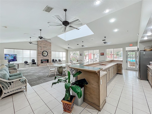 1150 Carmel Cir Unit 301, Casselberry, FL 32707 - kitchen featuring a wealth of natural light, open floor plan, vaulted ceiling with skylight, and ceiling fan
