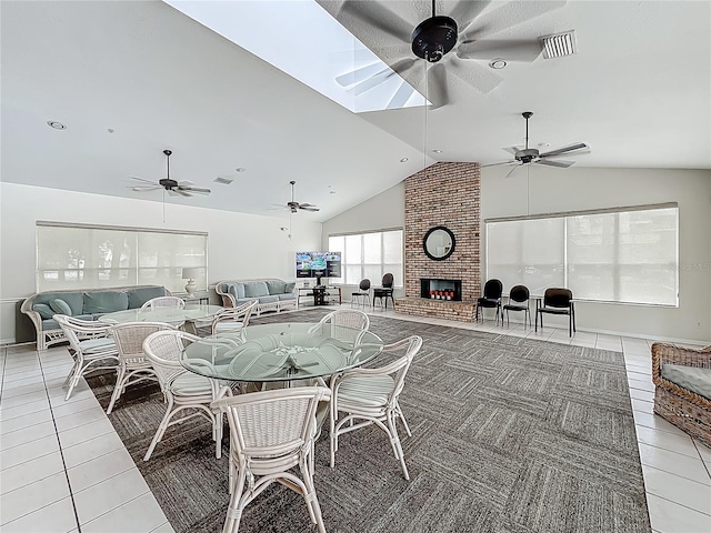 1150 Carmel Cir Unit 301, Casselberry, FL 32707 - dining room featuring light tile patterned floors, a brick fireplace, visible vents, ceiling fan, and high vaulted ceiling