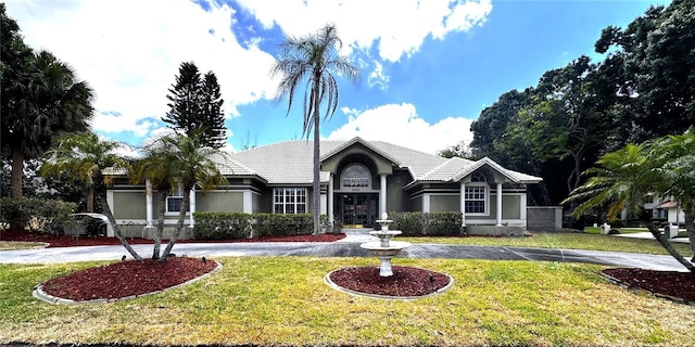 8935 Jonathan Manor Dr, Orlando, FL 32819 - single story home featuring curved driveway, a front yard, and stucco siding