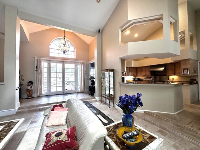 8935 Jonathan Manor Dr, Orlando, FL 32819 - living area featuring a chandelier, high vaulted ceiling, and baseboards
