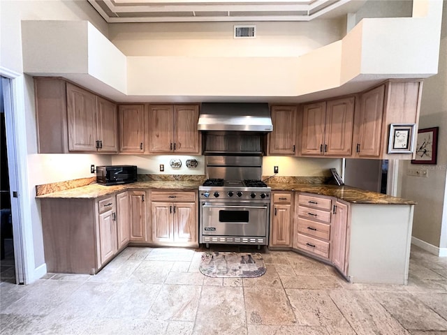 8935 Jonathan Manor Dr, Orlando, FL 32819 - kitchen with wall chimney range hood, designer stove, visible vents, and stone tile floors
