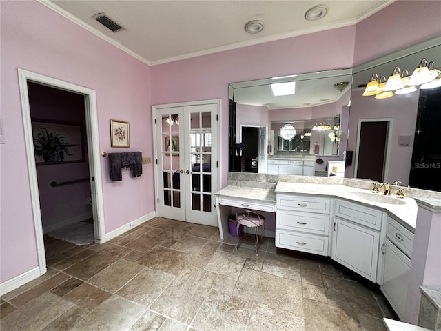 8935 Jonathan Manor Dr, Orlando, FL 32819 - bathroom with french doors, visible vents, stone tile floors, and crown molding