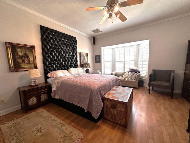 8935 Jonathan Manor Dr, Orlando, FL 32819 - bedroom with crown molding, visible vents, baseboards, and wood finished floors
