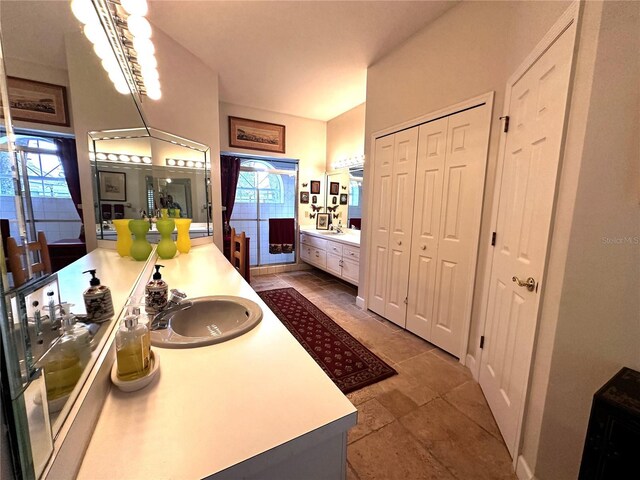 8935 Jonathan Manor Dr, Orlando, FL 32819 - bathroom featuring two vanities, a sink, and a closet