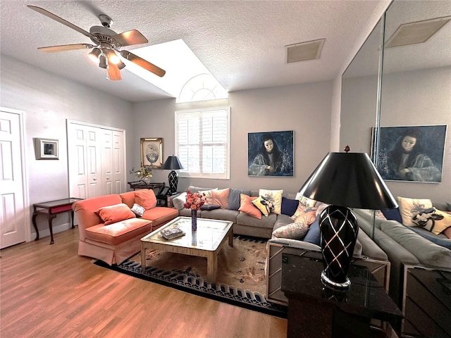 8935 Jonathan Manor Dr, Orlando, FL 32819 - living room with ceiling fan, a textured ceiling, visible vents, and wood finished floors