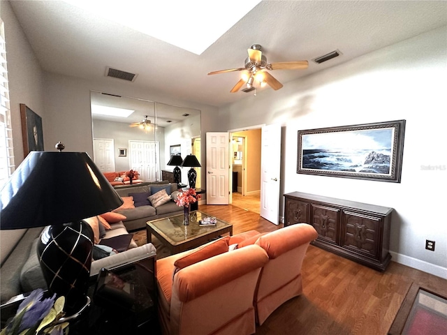 8935 Jonathan Manor Dr, Orlando, FL 32819 - living area featuring wood finished floors, ceiling fan, baseboards, and visible vents