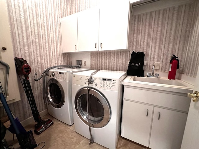 8935 Jonathan Manor Dr, Orlando, FL 32819 - washroom featuring cabinet space, wallpapered walls, washing machine and clothes dryer, and a sink