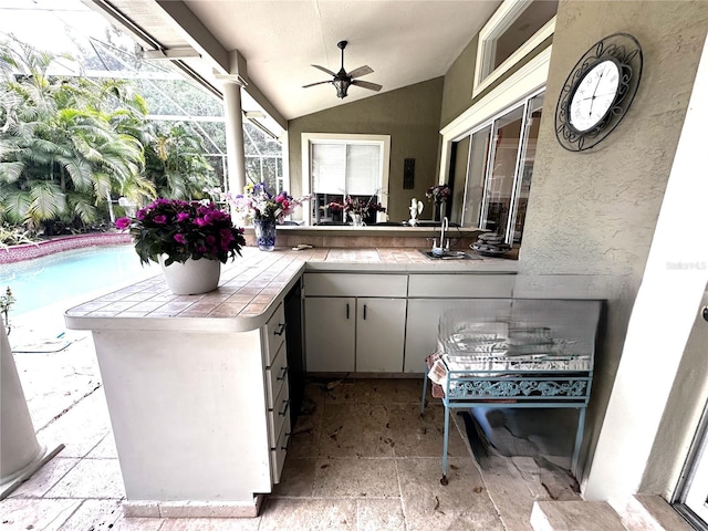 8935 Jonathan Manor Dr, Orlando, FL 32819 - view of patio / terrace with ceiling fan, an outdoor pool, a sink, exterior kitchen, and a lanai