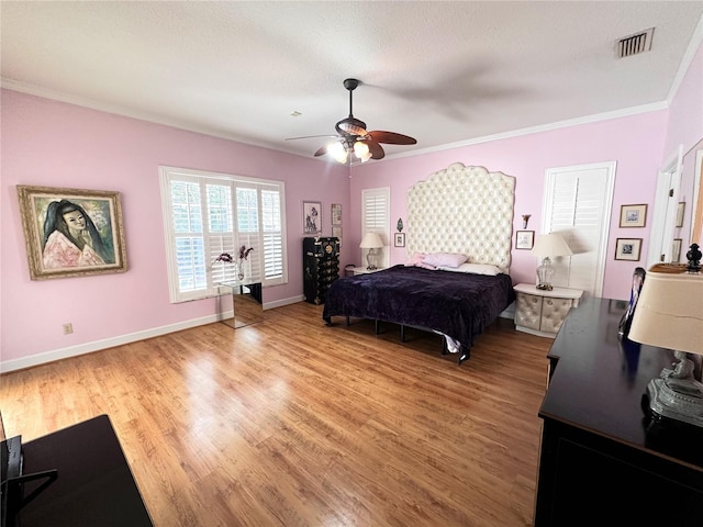 8935 Jonathan Manor Dr, Orlando, FL 32819 - bedroom featuring crown molding, visible vents, light wood-style flooring, and baseboards