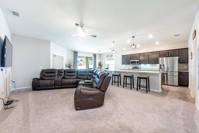 4231 Swan St, Haines City, FL 33844 - living room with ceiling fan, visible vents, recessed lighting, light carpet, and baseboards