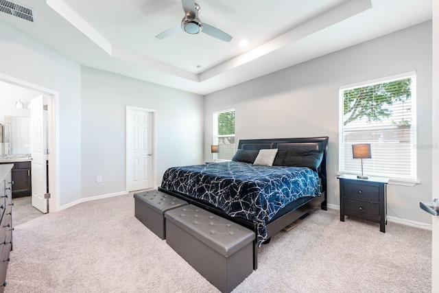 4231 Swan St, Haines City, FL 33844 - bedroom with a tray ceiling, light carpet, baseboards, and visible vents