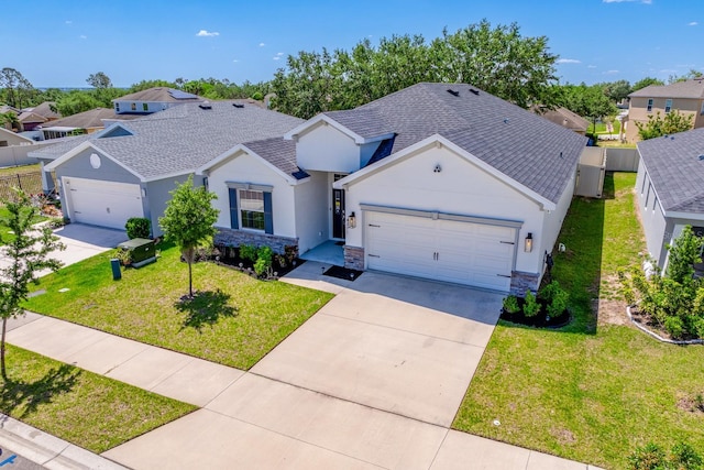 4231 Swan St, Haines City, FL 33844 - ranch-style home featuring an attached garage, concrete driveway, stucco siding, a front lawn, and roof with shingles