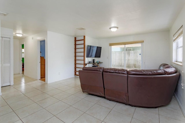 living room featuring light tile patterned floors and visible vents