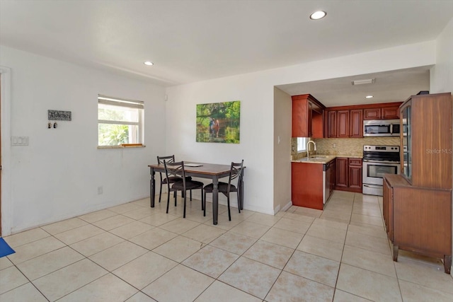 dining space with light tile patterned floors and recessed lighting
