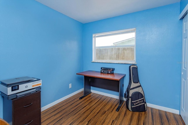 office area with baseboards and dark wood finished floors