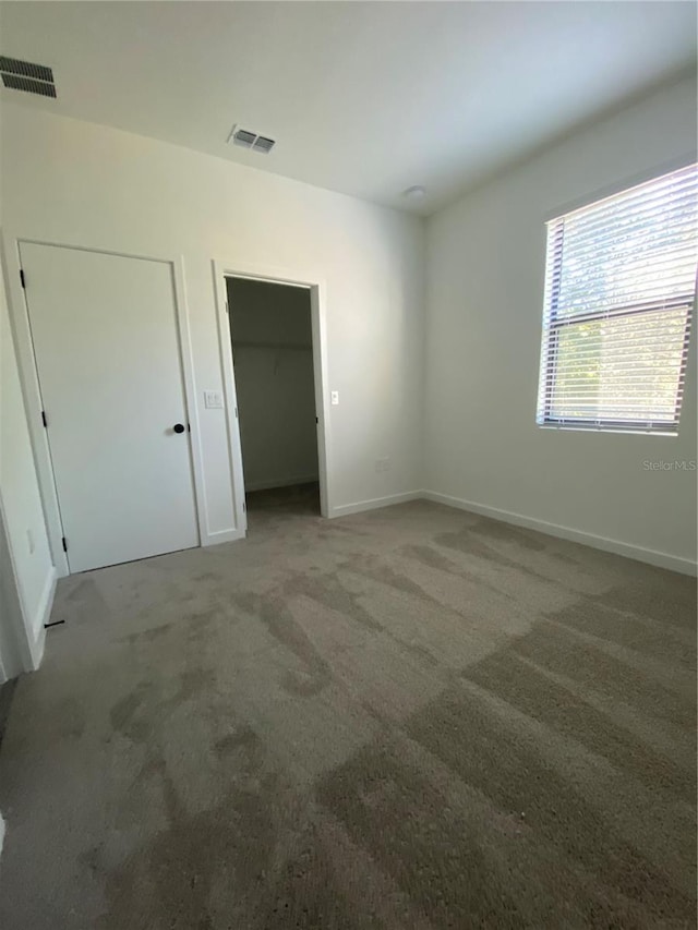 3432 Tranquil Trl, Kissimmee, FL 34747 - unfurnished bedroom featuring carpet, baseboards, and a spacious closet