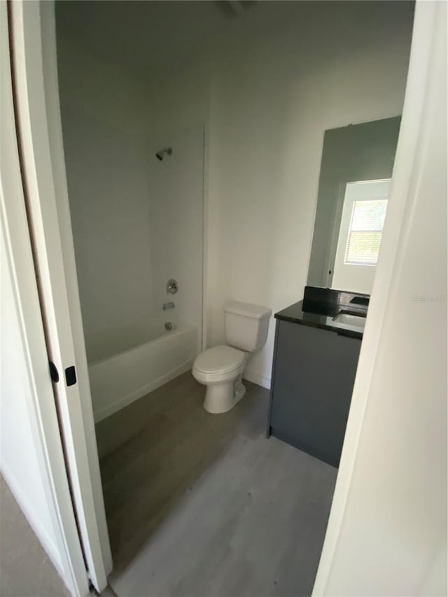 3432 Tranquil Trl, Kissimmee, FL 34747 - full bath with toilet, vanity, shower / bathtub combination, and wood finished floors