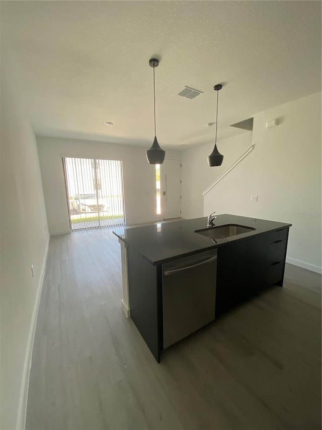 3432 Tranquil Trl, Kissimmee, FL 34747 - kitchen featuring dishwasher, a sink, wood finished floors, baseboards, and a textured ceiling