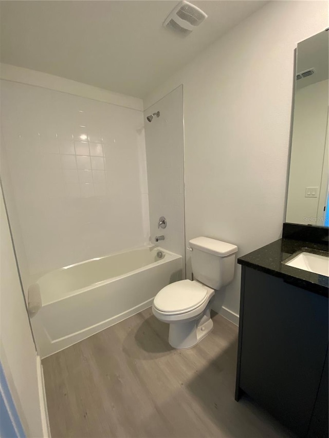3432 Tranquil Trl, Kissimmee, FL 34747 - bathroom featuring wood finished floors, toilet, vanity, and shower / bath combination